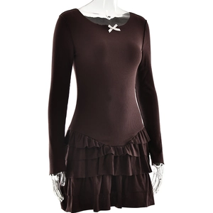 Detail of dark brown ruffled mini dress with tiered skirt and white bow on neckline