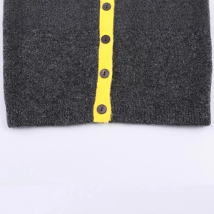 Women's dark grey knit cardigan with a bright yellow contrast placket and button details