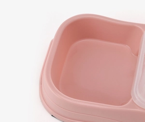 Detail of pink plastic pet bowl featuring a smooth rounded edge and a transparent lid