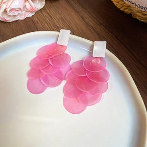 Macro shot of pink layered shell petals with white stud on a white ceramic plate
