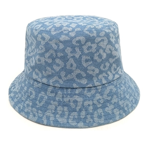 Macro detail of leopard print pattern on light blue denim fabric of the bucket hat