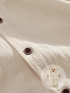 Macro detail of breathable cotton linen fabric with vintage buttons and hooded drawstring