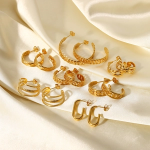 Detail of 18K gold plated stainless steel hoop earrings on ivory silk fabric