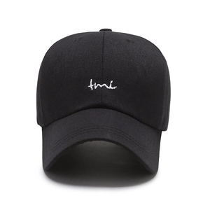 Classic black cotton baseball cap with white TMI embroidery on front view