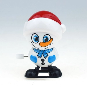 Close-up of wind-up walking snowman toy with red hat and blue scarf details