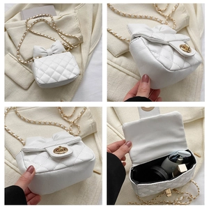 Detailed views of white quilted mini chain bag with bow accent and interior storage