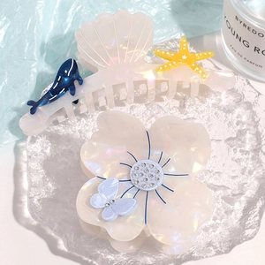Floral acetate hair claw set featuring pearlescent shell and butterfly designs