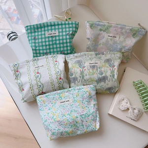 Set of five floral and plaid cotton cosmetic bags with zippers in a stylish layout