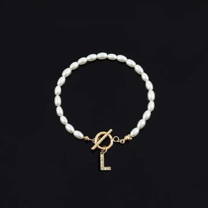 Fashionable faux pearl bracelet with gold letter L rhinestone pendant and OT clasp closure