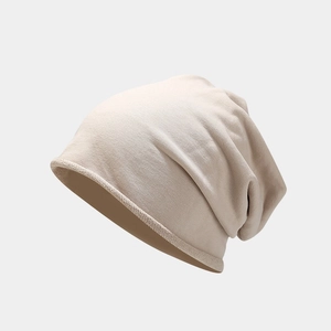 Close-up of beige knit beanie showing soft ribbed texture and natural rolled edge detail