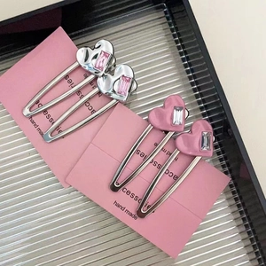 Y2K metallic heart hair clips with butterfly and rhinestone accents in silver and pink