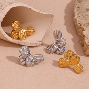 Detail shot of vintage geometric floral earrings in gold and silver stainless steel