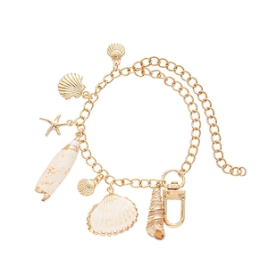 Golden starfish and seashell charm bracelet with beach-inspired aesthetic for women