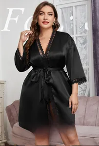 Close-up of elegant black satin robe featuring intricate eyelash lace trim on sleeves