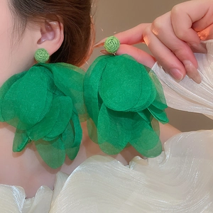 Exaggerated green layered organza flower drop earrings on model for vacation