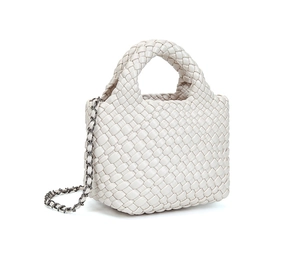 Detailed view of woven beige crossbody bag with leather texture and metal chain strap