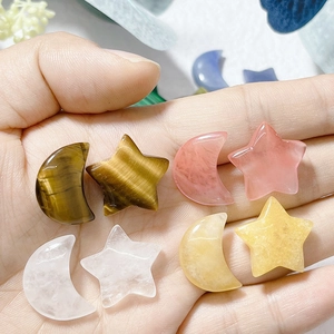 Natural crystal moon and star stones in hand, showing various gemstones for home decor