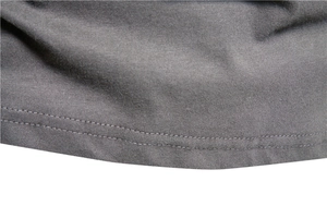 Macro shot of double-stitched hem on a dark grey cotton knit long-sleeve T-shirt
