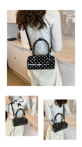 Detailed views of a black polka dot patent leather Boston bag with crossbody strap