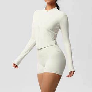 Detail of slim fit yoga set featuring high-waist shorts and full-zip long sleeve top