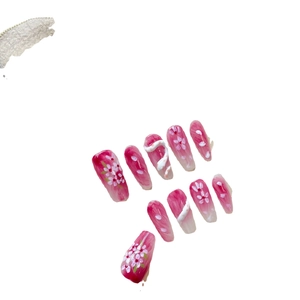 Pink gradient long coffin press-on nails with cherry blossom patterns and 3D relief art