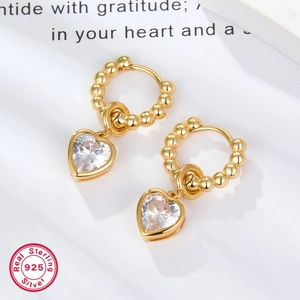Detail of s925 gold-plated sterling silver heart earrings with sparkling zircon stones