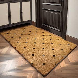 Brown coconut fiber doormat with black diamond pattern shown on wooden floor