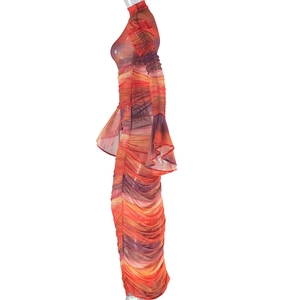 Detail of ruched mesh long sleeve dress featuring flare cuffs and tie-dye print patterns