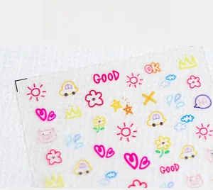 Close-up of matte 5D graffiti nail art stickers with sun and heart patterns