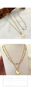 Detail of double-layer butterfly necklace in gold titanium steel with colorful drip oil