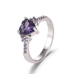 Sparkling silver heart-shaped purple amethyst ring with side stones in a 45-degree angle