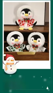 Three plush Christmas penguins in colorful knit sweaters with bells on a wooden shelf