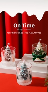 Detailed view of handmade Christmas tree candles in frosted glass jars with festive bows