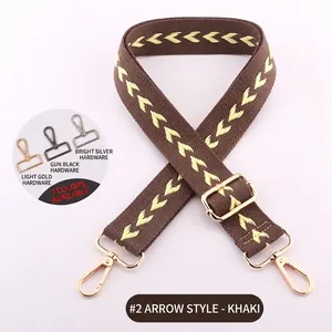 Detailed view of khaki woven shoulder strap with arrow patterns and three hardware color options
