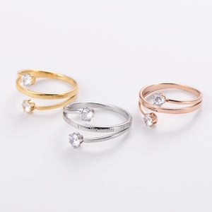 Three-tier stackable rings in gold, silver, and rose gold with zircon stones and roman numerals