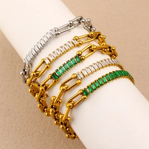 Detail of horseshoe chain bracelets with square zircons in gold and silver finish