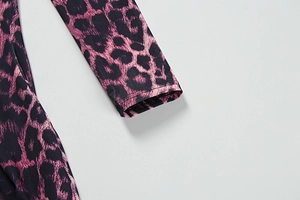 Close-up of the long sleeve cuff and sewing detail on a purple leopard print dress