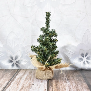 Mini green artificial Christmas tree with burlap base for holiday tabletop decoration