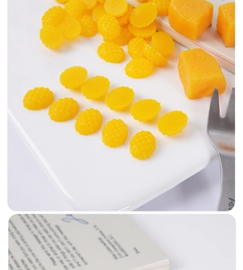 Detailed view of 1.5cm miniature fake mango cubes and resin fruit accessories on a tray