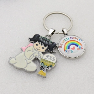 Macro shot of metal enamel keychain with angel IHS chalice and rainbow Schulkind charms