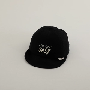 Detailed embroidery on a black cotton baby cap with a soft brim and white lettering