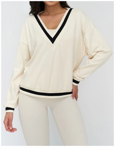 Detail of color-block V-neck sweatshirt set with striped cuffs and loose athletic fit