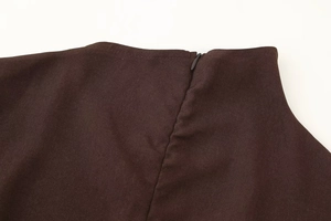 Detail view of dark brown dress featuring a seamless invisible zipper and fine stitching