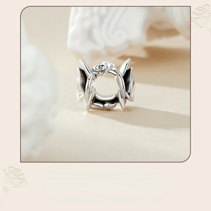 Macro shot of 925 sterling silver hollow rose flower bead charm for DIY bracelets
