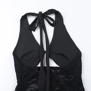 Detailed close-up of black lace halter neckline and hollow back stitching on the dress