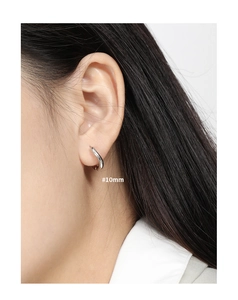 Close-up of 10mm irregular round hoop earring in S925 sterling silver on model's ear