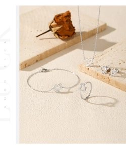 S925 sterling silver heart jewelry set with necklace and ring on a beige stone