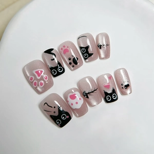 Cat-themed press-on nails with pink cat eye shimmer and cute kitten hand-painted designs
