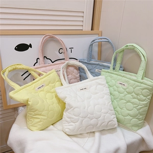 Detailed view of candy color floral quilted tote bags in five soft pastel color options
