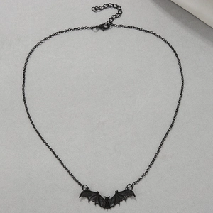 Macro shot of gothic black bat pendant necklace featuring detailed wing textures